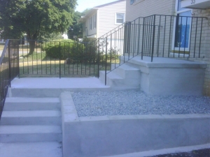 Concrete stairway and porch with retaining wall